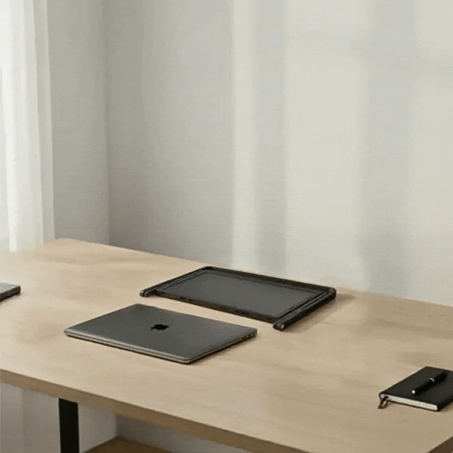 GIF showing the Doxa Pro 3 unfolding into a full triple-monitor workstation from a compact portable form