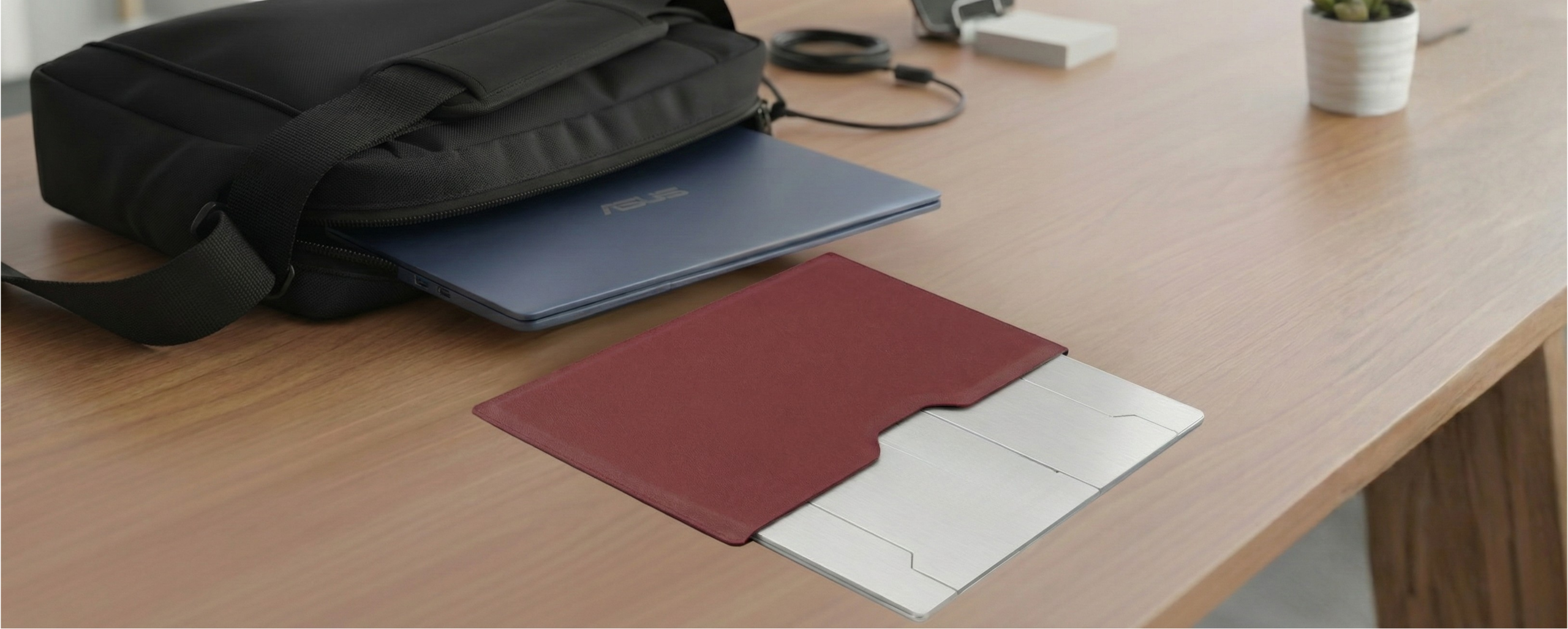 Oryx Evo D folded flat next to a laptop sleeve and bag, ready for travel.